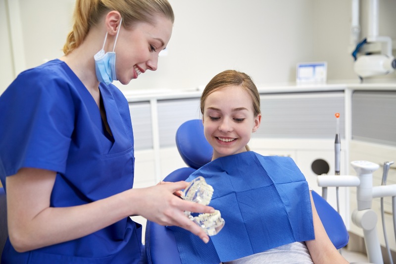 Dentist explaining all-on-4 denture process to a patient in Tempe, AZ